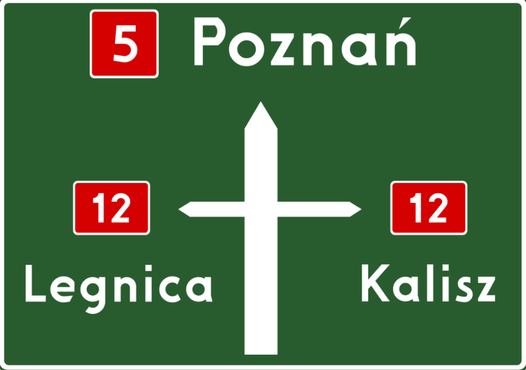 znak na zielonym tle z rozjazdem dróg i nazwami miejscowości w białym kolorze