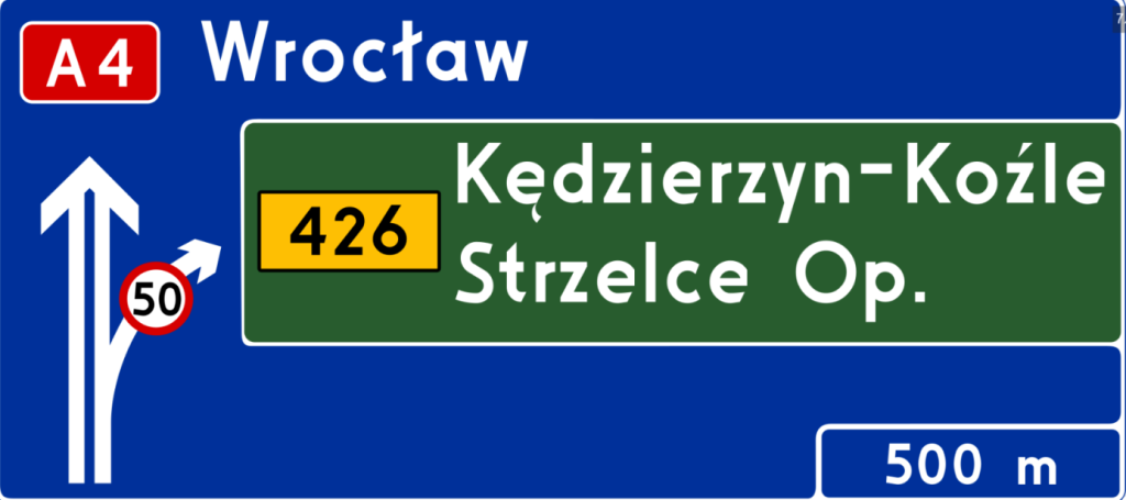 tablica z niebiesko-zielonym tłem, rozjazdem i nazwami miejscowości w białych kolorach