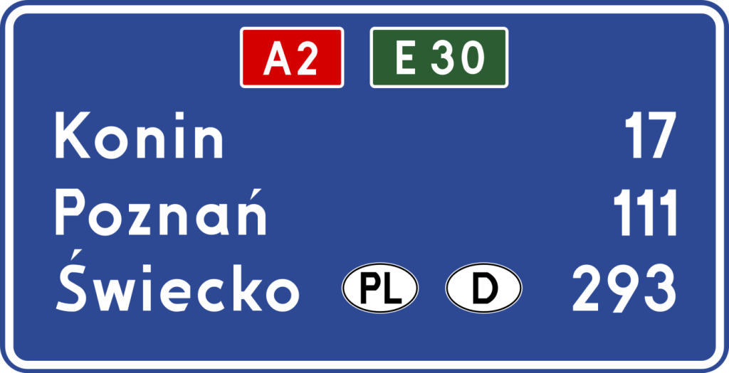 tablica z niebieskim tłem, białymi napisami i oznaczeniami dróg w kolorach czerwonym i zielonym